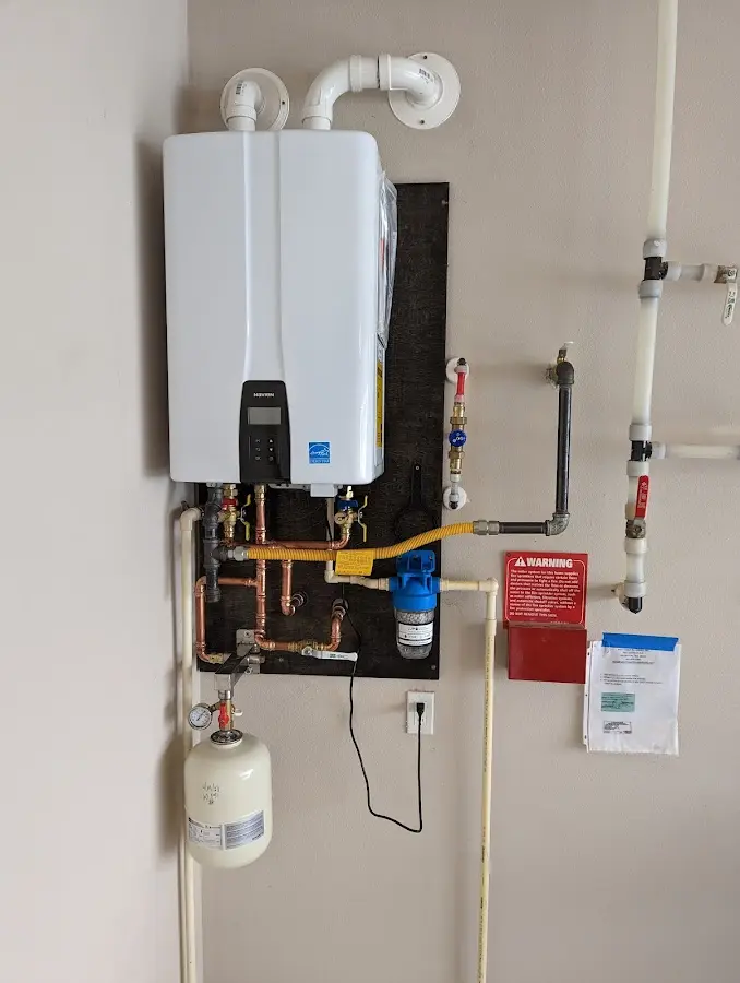 Professional plumber installing copper piping in a Katy home